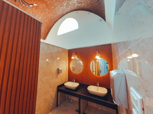 a bathroom with two sinks and two mirrors at Safari Beach Nuweiba in Nuweiba