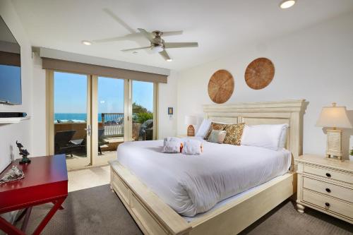 a bedroom with a large bed with a view of the ocean at Water Front Spectacular Ocean View Large Balcony AC Pet Friendly in Oceanside