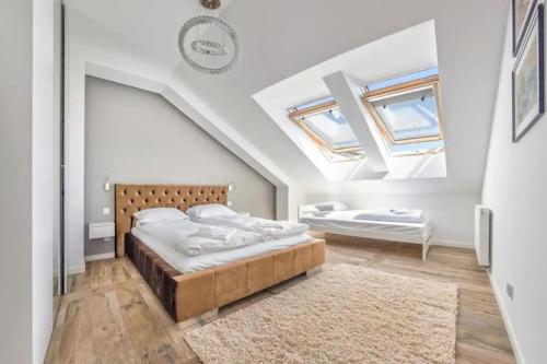 a bedroom with a bed and a skylight at Golden Apartments Gdansk&SwB12 in Gdańsk
