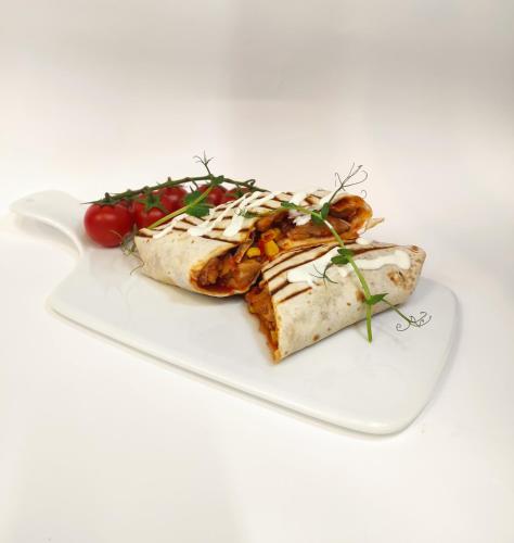 a white plate with food on a white background at Hotel Lilia in Włoszczowa