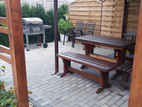 a patio with a picnic table and a grill at Ubytovani PASO na Palave in Pasohlávky