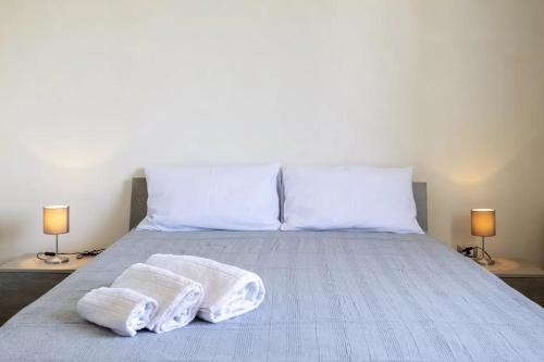 a bed with two towels on it with two lamps at Home Paradise in Marsala