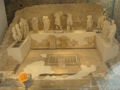 a exhibit in a museum with statues on the floor at Apartman Olimp in Metković