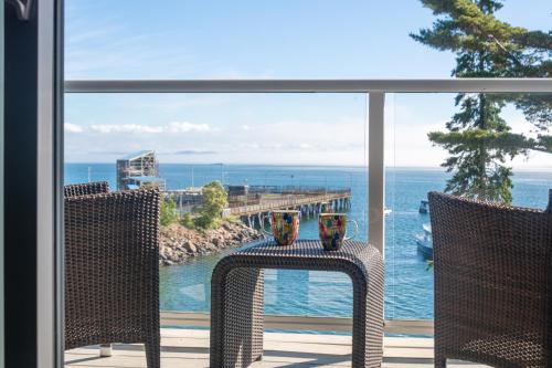 a balcony with a view of the ocean and a pier at Atlantic Oceanside Hotel & Conference Center in Bar Harbor