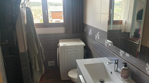 a small bathroom with a toilet and a sink at CHEZ ANTOINE in Saint-Pierre-dels-Forcats