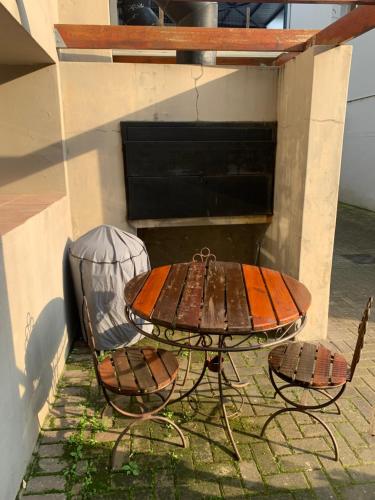 a table and chairs with a surfboard on top of it at The Tipsy Expat in Paarl