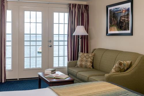 a hotel room with a couch and a bed at Atlantic Oceanside Hotel & Conference Center in Bar Harbor