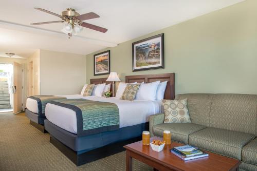 a hotel room with a bed and a couch at Atlantic Oceanside Hotel & Conference Center in Bar Harbor
