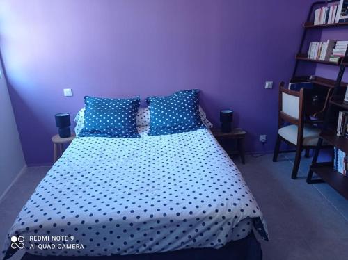 a bedroom with a bed with a polka dot bedspread at Loft vue Palais des Papes in Avignon