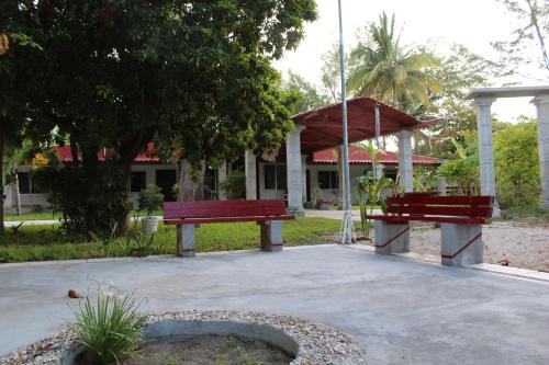 two benches in a park with a gazebo at Freedom Shores "La Gringa" Hotel - Universally Designed in Isla Aguada