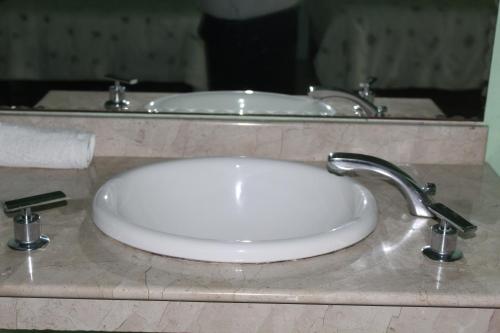 a white sink in a bathroom with a mirror at Freedom Shores "La Gringa" Hotel - Universally Designed in Isla Aguada