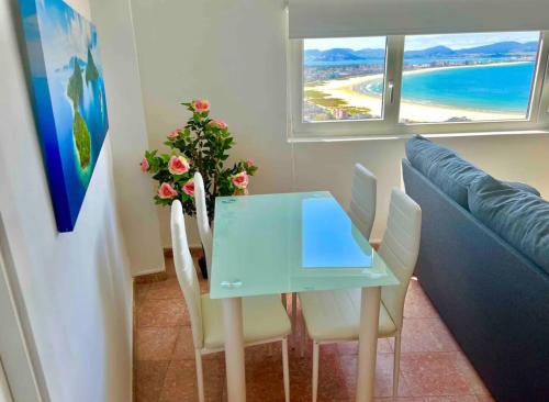ein Esszimmer mit einem blauen Tisch und Stühlen in der Unterkunft Encantador apartamento recién reformado a estrenar in Laredo