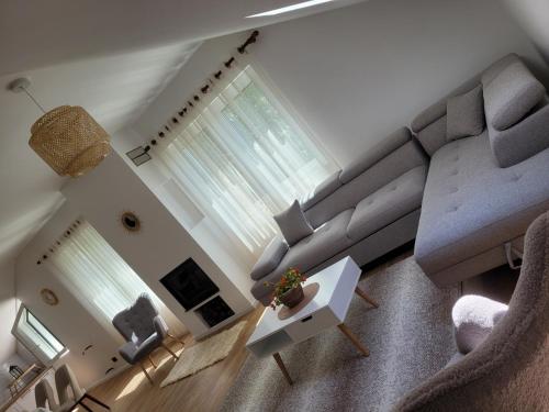 a living room with a couch and a table at Bujtina Bezhani Gjinar in Elbasan