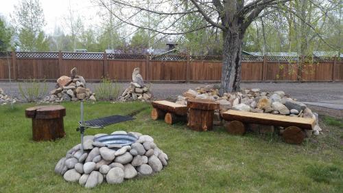 a bunch of logs sitting in the grass in a yard at Long Holiday Motel in Gunnison