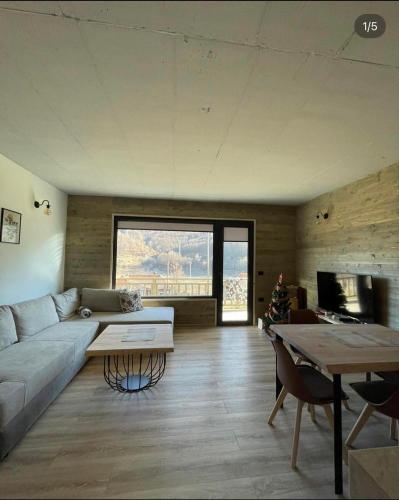 a living room with a couch and a table at Mavrovo Apartment in Mavrovo