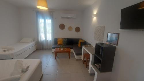 a small living room with a couch and a table at Niso in Livadion