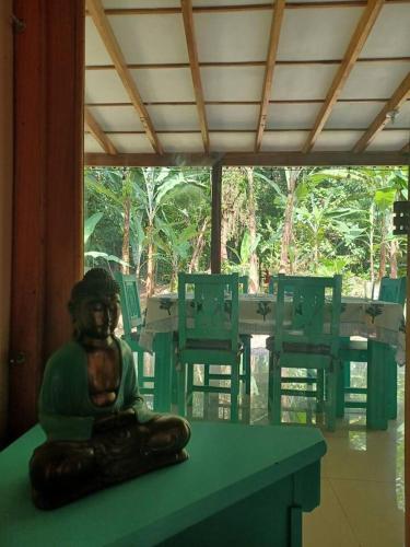 a statue sitting on a table in a room at Casa Lucas in Cahuita