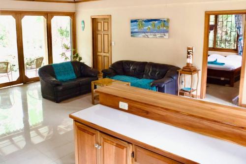 a living room with two couches and a table at Casa Lucas in Cahuita