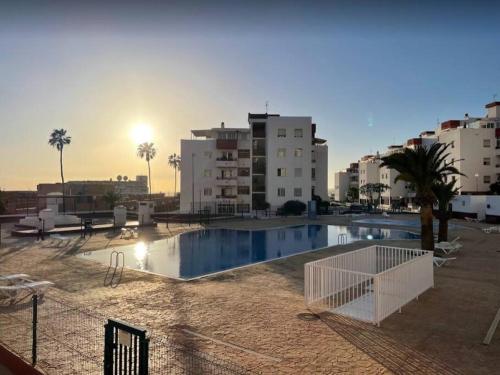 a large swimming pool in front of some buildings at Apartamento céntrico de estilo nórdico in Adeje
