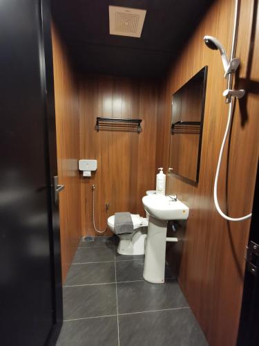 a bathroom with a toilet and a sink at Tatami D'Tepi Laut - PANGKOR ISLAND in Pangkor