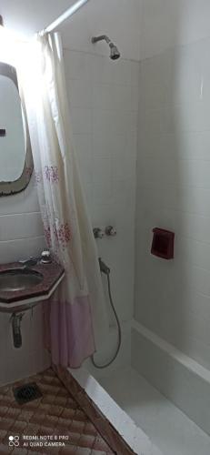 a bathroom with a shower and a sink at La colina in Roldán