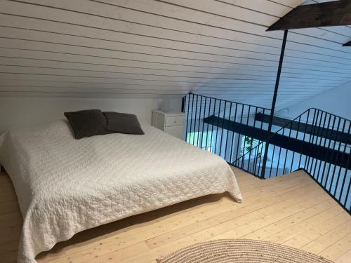 a bedroom with a bed and a balcony at Lilla Stenhuset in Ystad