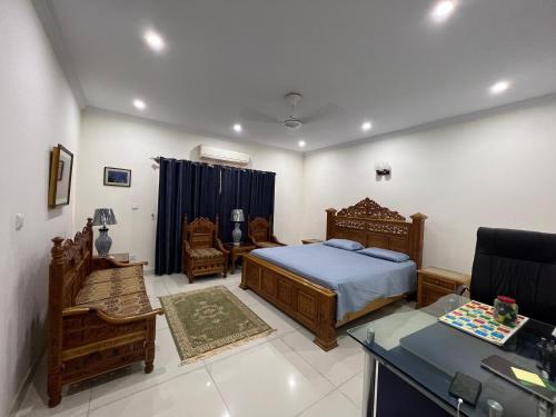 a bedroom with a bed and a desk at DHA 2 Islamabad in Islamabad