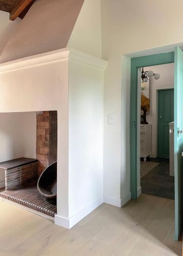 a living room with a fireplace in a house at Casa Luis Pato in Óis do Bairro