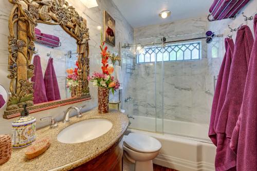 a bathroom with a sink and a mirror and a toilet at Bohemian Wonderland Benicia Bungalow with Pergola! in Benicia