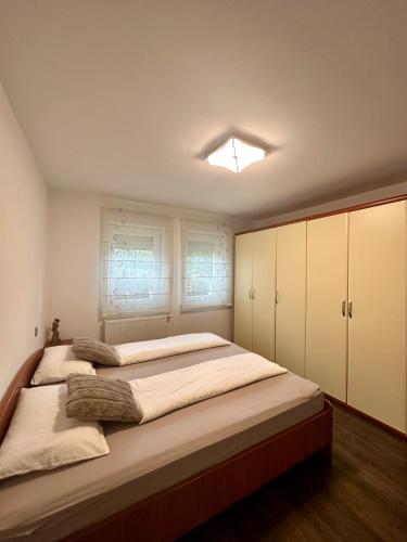 a bedroom with a large bed with white cabinets at Hiša Helena in Kranj