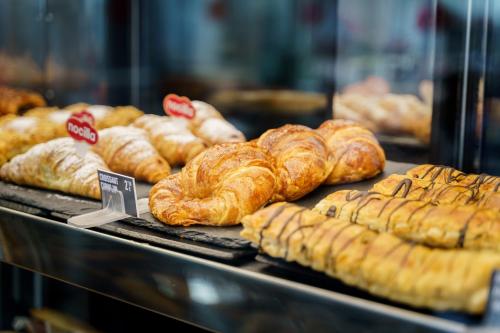 uma vitrine numa padaria com croissants e outros produtos de pastelaria em AS HOTELES FUENTE LA HIGUERA direccion Valencia em Fuente la Higuera