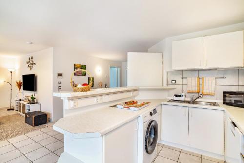 a kitchen with white cabinets and a dishwasher at Bei s' Herrs in Rheinmunster