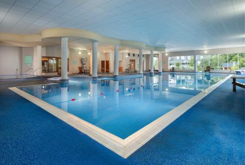 a large swimming pool in a hotel with blue water at Arklow Bay Hotel in Arklow