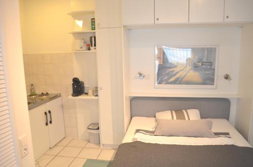 a small room with a bed and a bathroom at AV No.1 in Düsseldorf