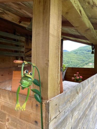 a toy frog on the side of a building with a window at Household Babovic - Old house Miljan's valley in Andrijevica