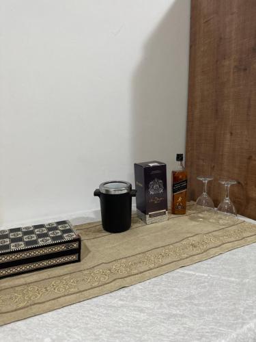 a table with a tray with glasses and a bottle of whiskey at Elias Basilica Rooftop Penthouse in Nazareth