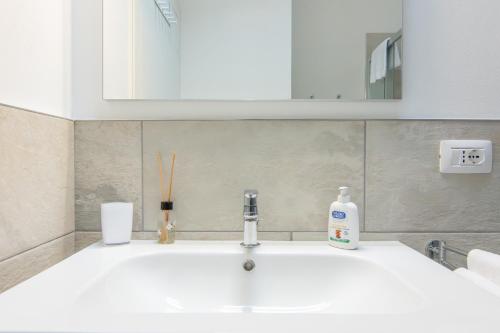 a bathroom sink with a bottle of soap on it at R&B al lago in Domaso