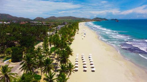 an aerial view of a beach with palm trees and the ocean at Hesperia Playa el Agua in El Agua