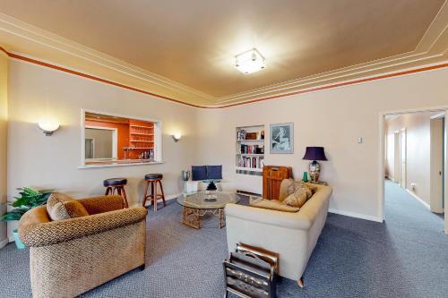 a living room with two chairs and a couch at Eureka Theatre Apartment in Eureka