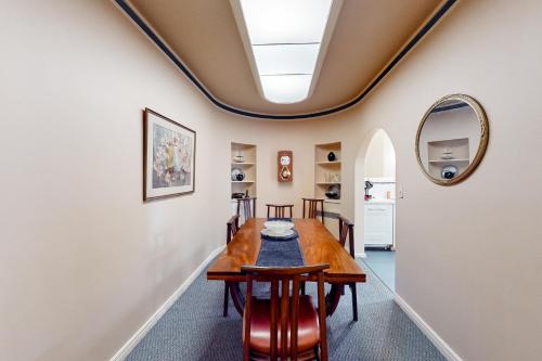 a dining room with a table and chairs and a mirror at Eureka Theatre Apartment in Eureka