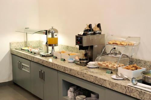 a kitchen with a counter with pastries on it at Hotel México Plaza Irapuato in Irapuato