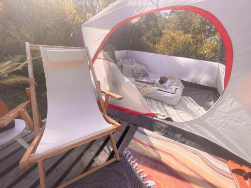 a tent with a chair and a mirror at eco-dome off-grid garden glamping in Bithlo