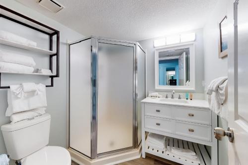 a bathroom with a shower and a toilet and a sink at Pelican Beach Resort 1205 in Destin