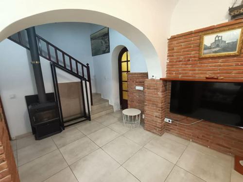 a living room with a fireplace and a brick wall at Apartamento Casa de pueblo in Sant Feliu de Guíxols