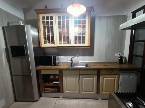 a kitchen with a stainless steel refrigerator and a sink at Apartamento Casa de pueblo in Sant Feliu de Guixols