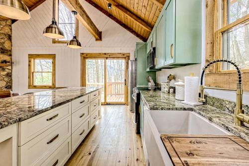 a kitchen with green cabinets and a wooden ceiling at The Treehouse in Hood