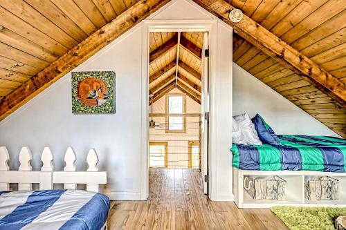two beds in a attic bedroom with wooden ceilings at The Treehouse in Hood