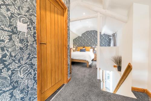 a room with a bed and a door leading to a bedroom at The Black Dog Apartment in Dalton in Furness