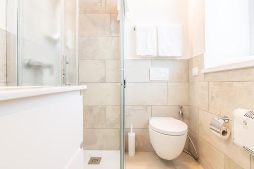a bathroom with a toilet and a glass shower at R&B al lago in Domaso