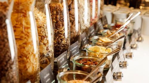 a row of jars filled with different types of food at Holiday Inn Dresden - Am Zwinger by IHG in Dresden